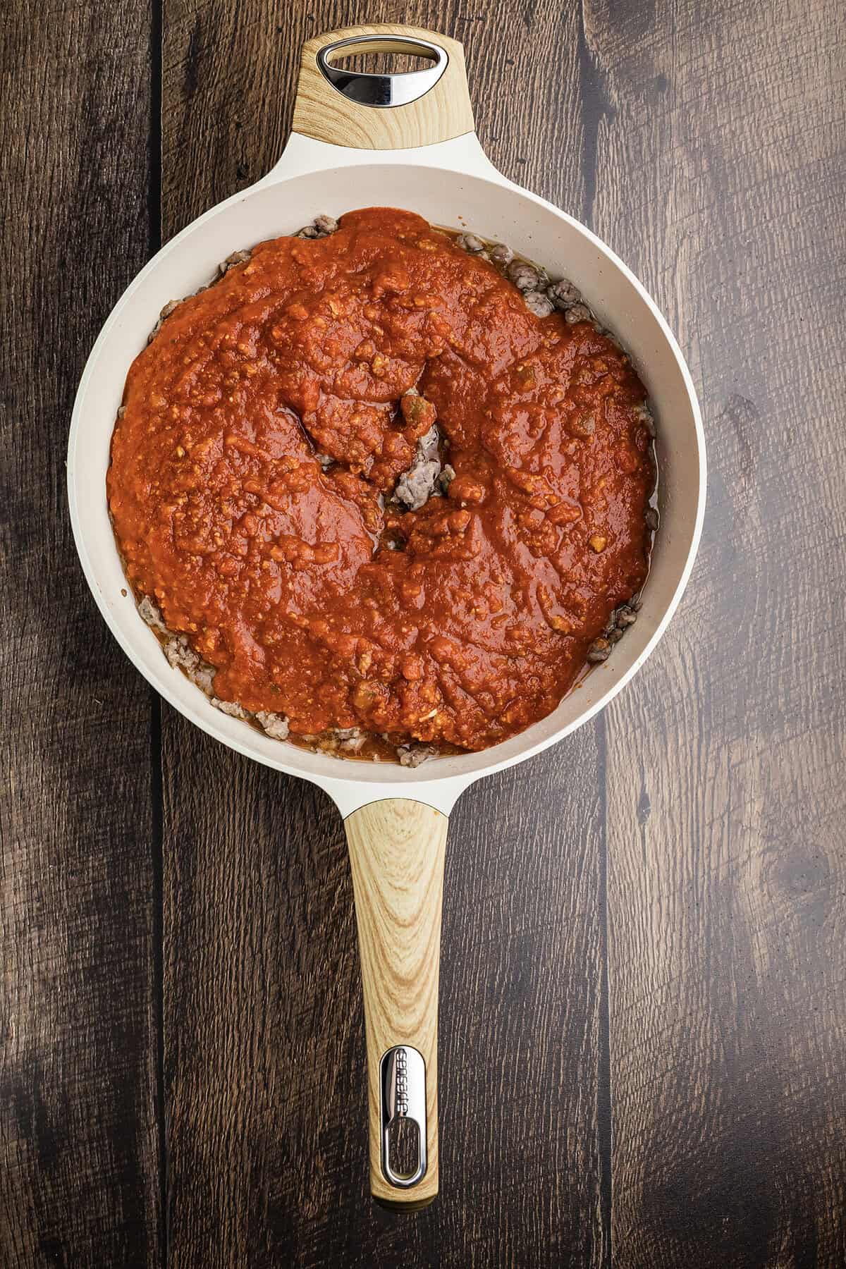Sausage and marinara in skillet.