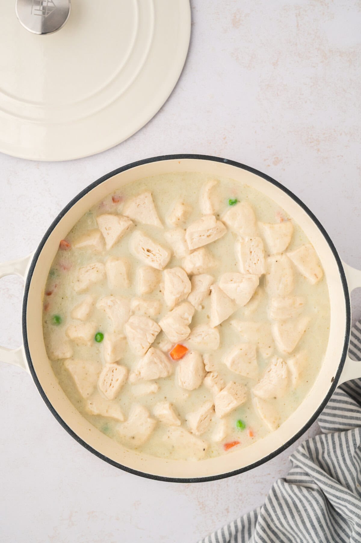 Dumplings added to pot of soup.