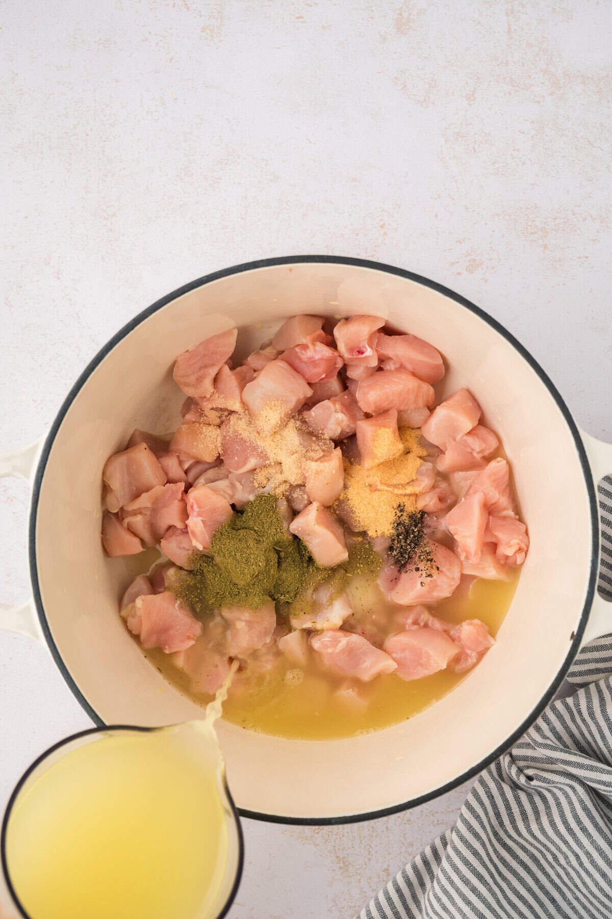 Chicken and seasoning in dutch oven.