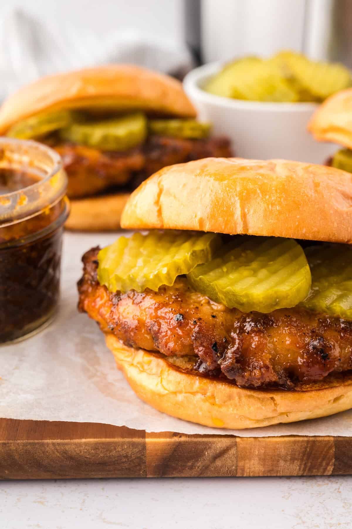 Nashville hot chicken sandwich topped with pickles.