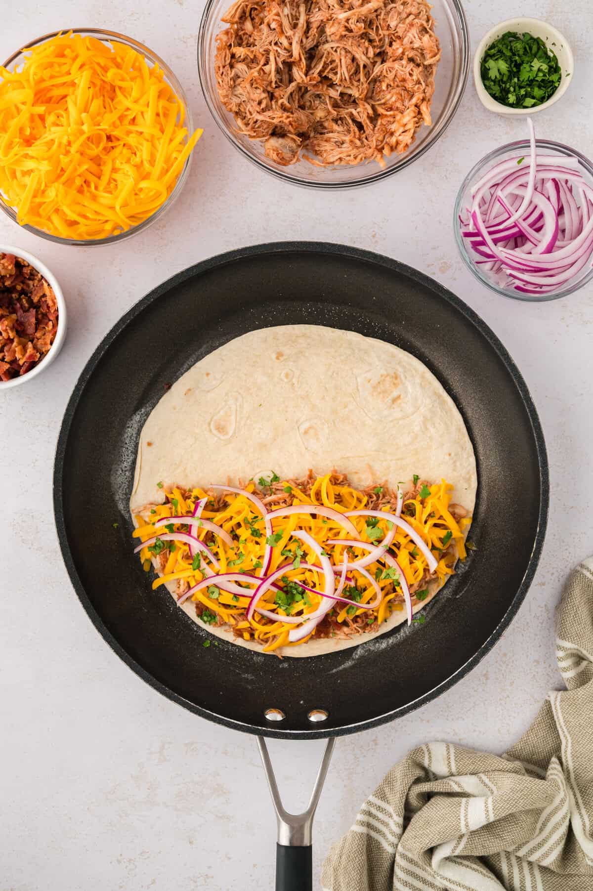 Assembled quesadilla in skillet.