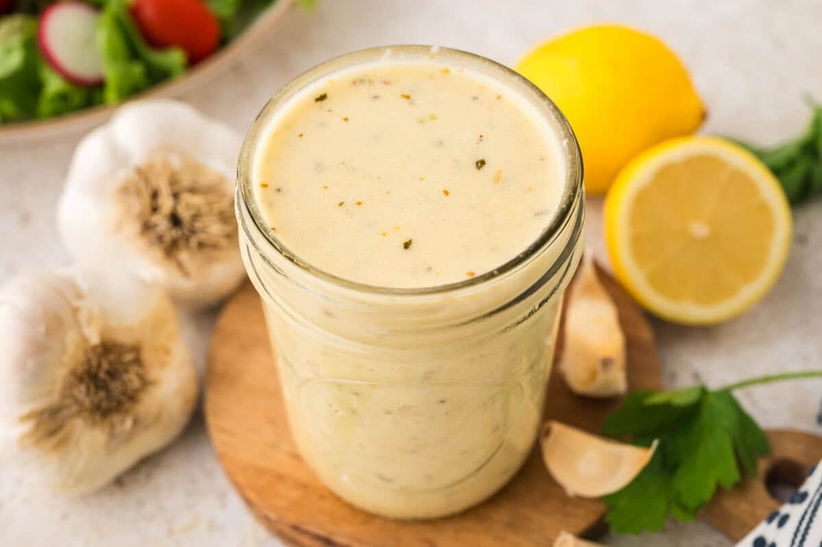 Jar full of homemade garlic dressing.