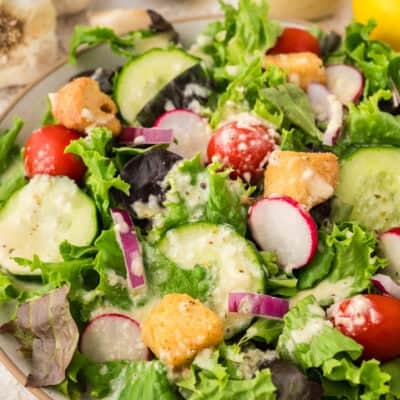 Green salad topped with garlic salad dressing.