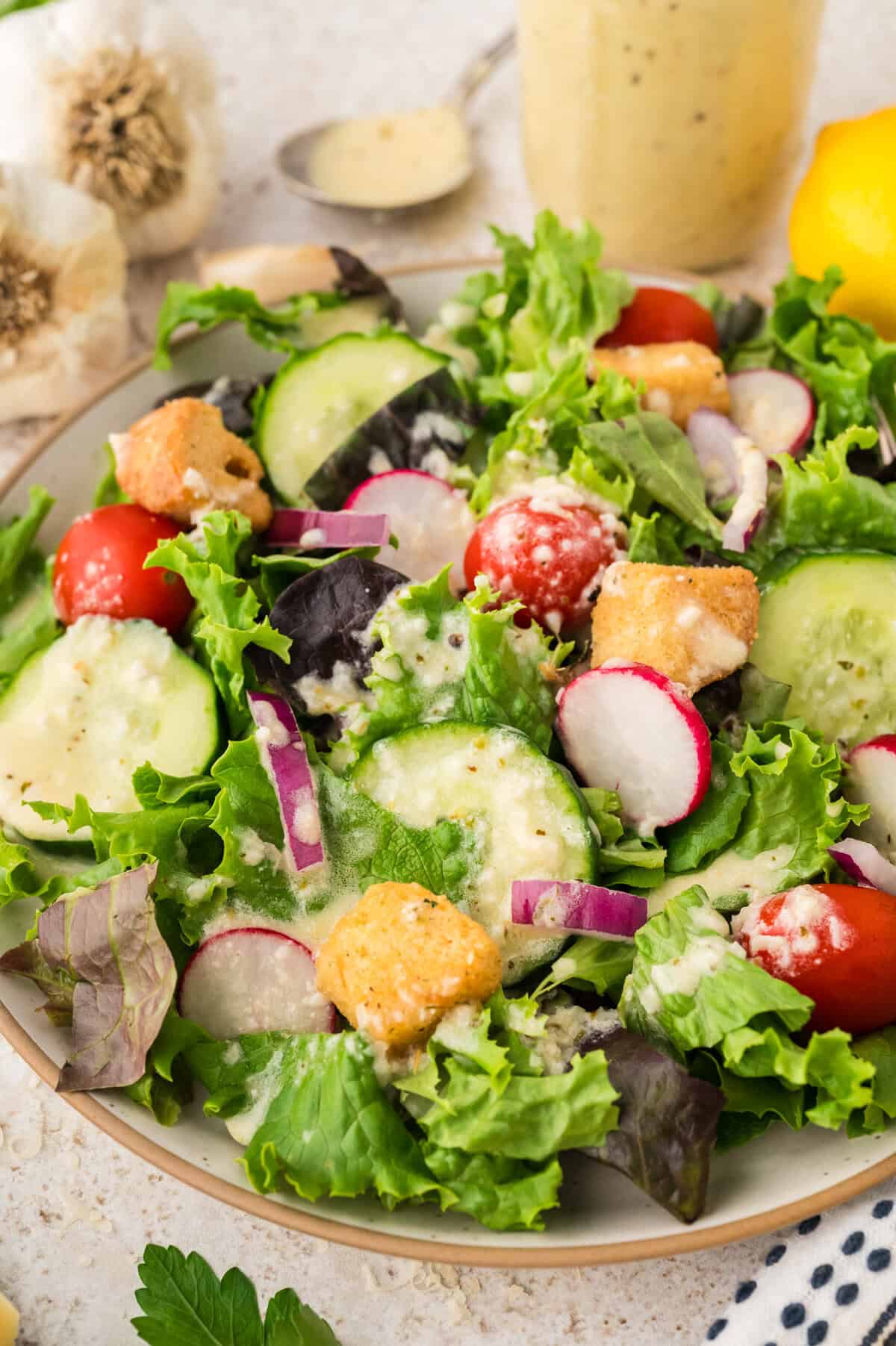 Green salad topped with garlic salad dressing.