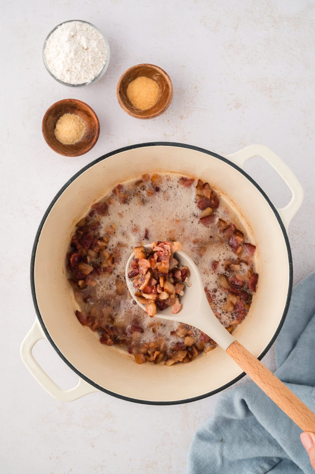 Fried bacon pieces in pot.
