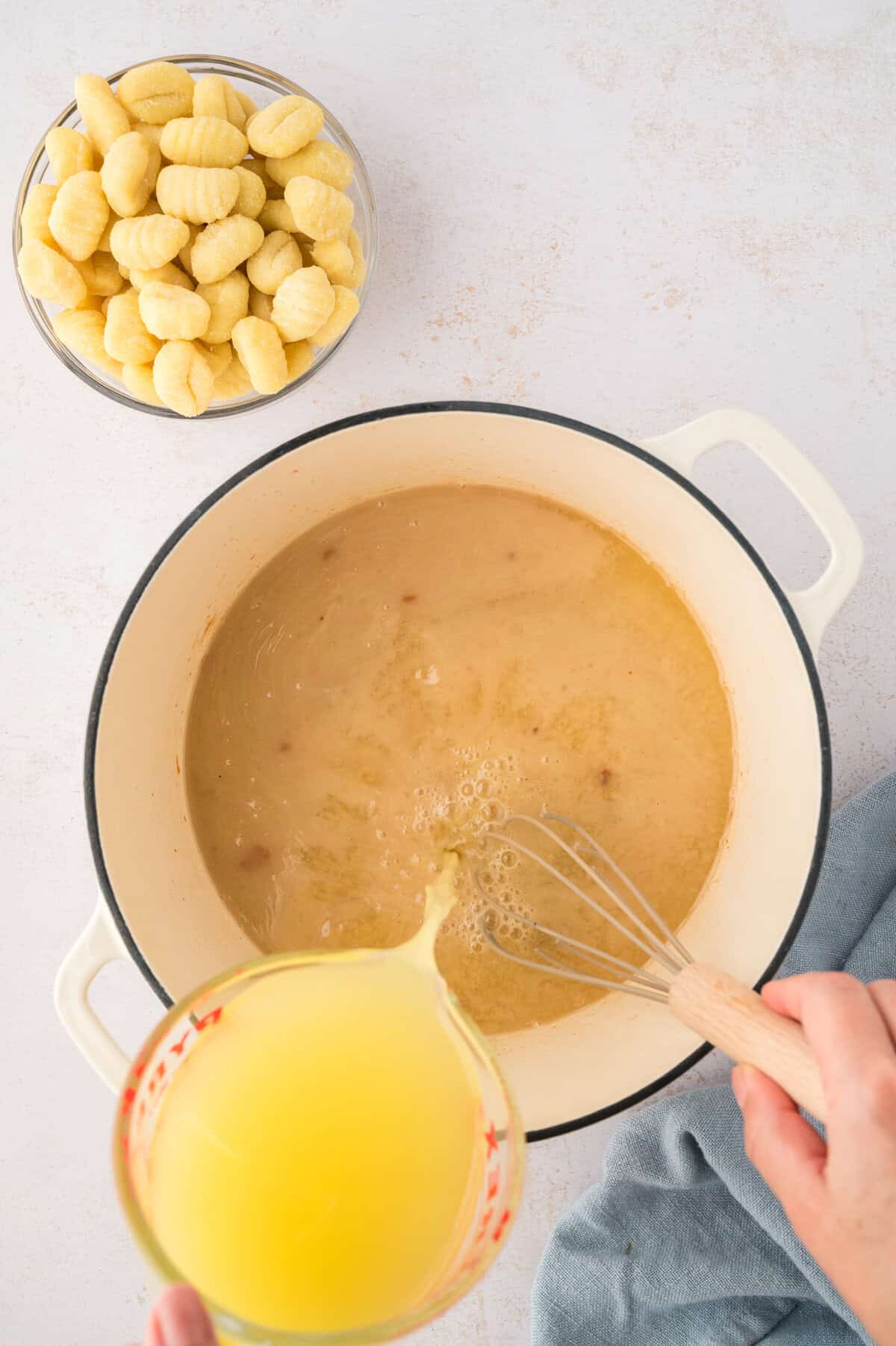 Broth being aded to roux.