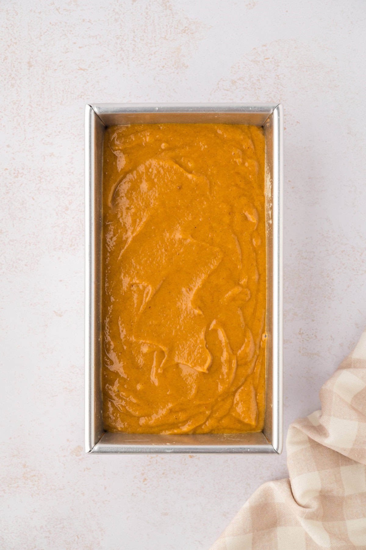Batter for pumpkin bread in a bread pan.