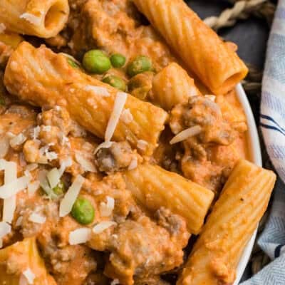 Creamy sausage pasta on plate.