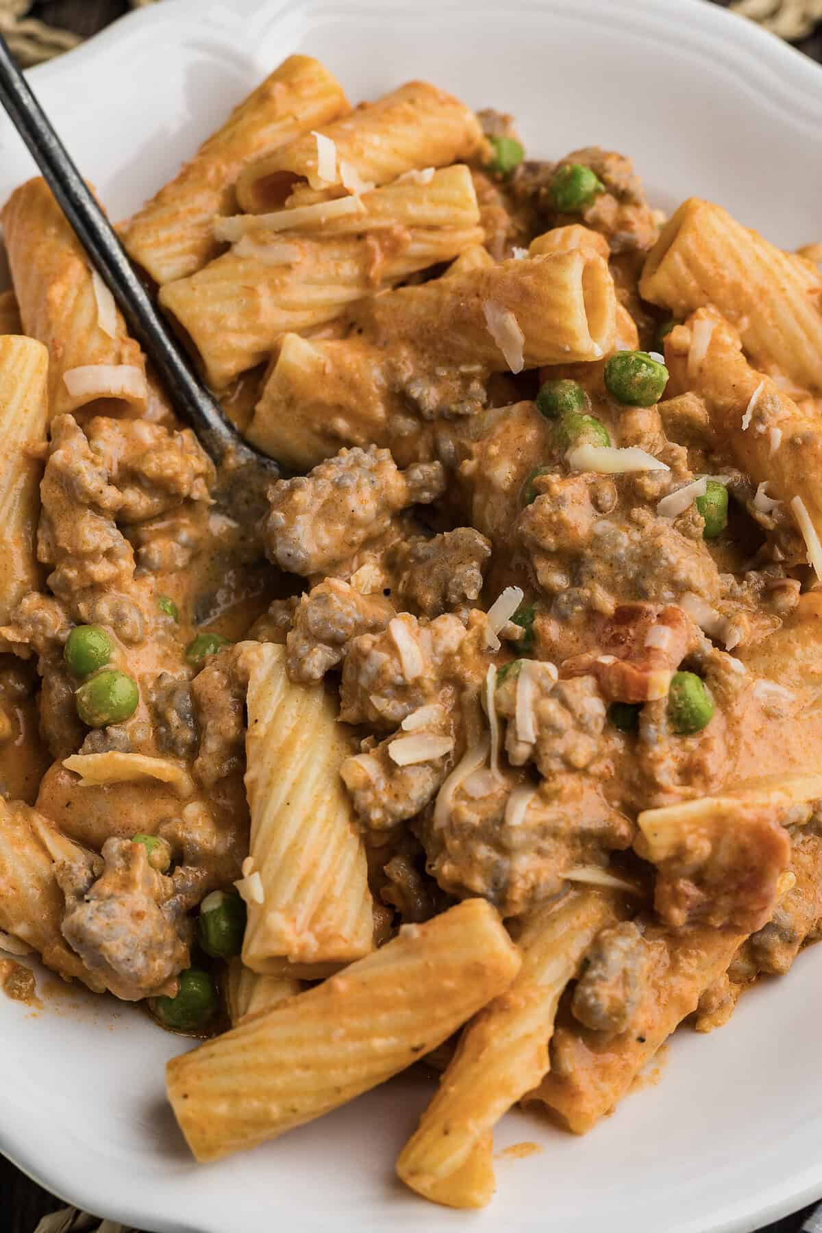 Fork full of creamy sausage pasta recipe.