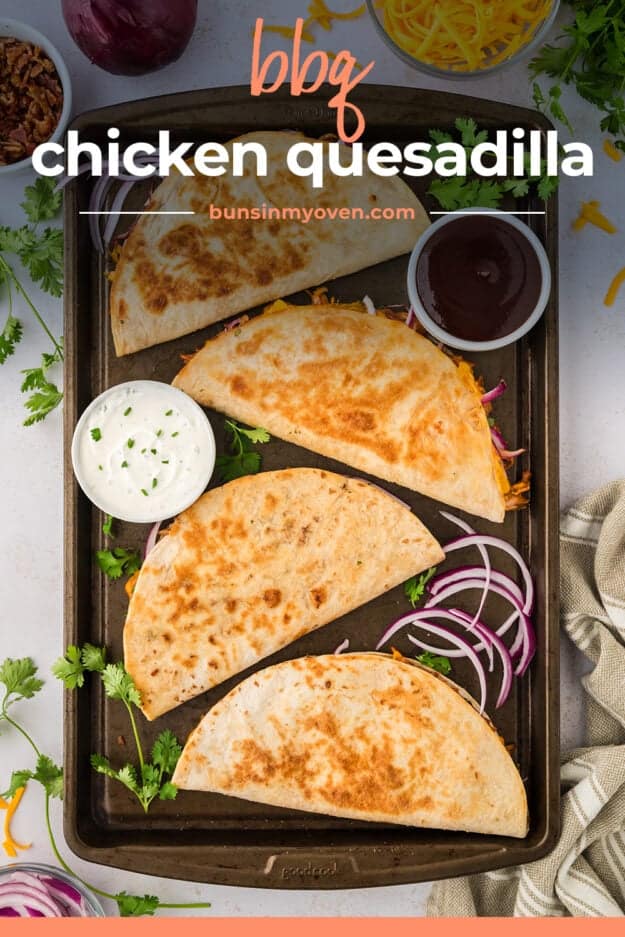 Sheet pan full of chicken quesadilla with bbq, bacon, and red onion.