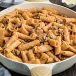 Italian sausage pasta recipe in skillet.