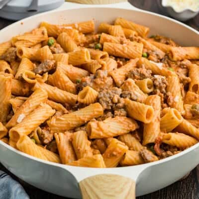 Italian sausage pasta recipe in skillet.