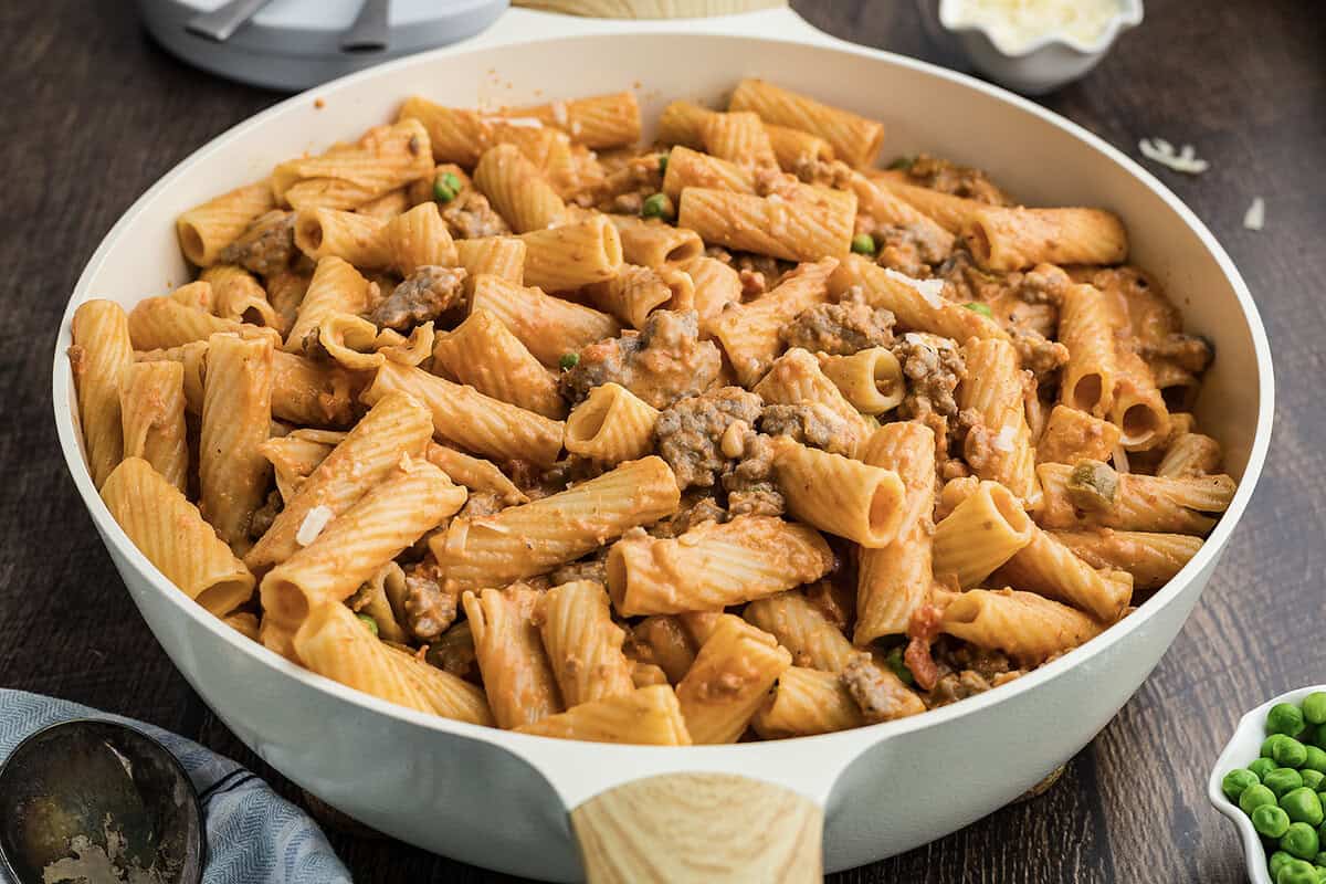 Italian sausage pasta recipe in skillet.