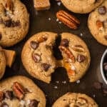Browned butter turtle cookie recipe on baking sheet with chocolate chips.