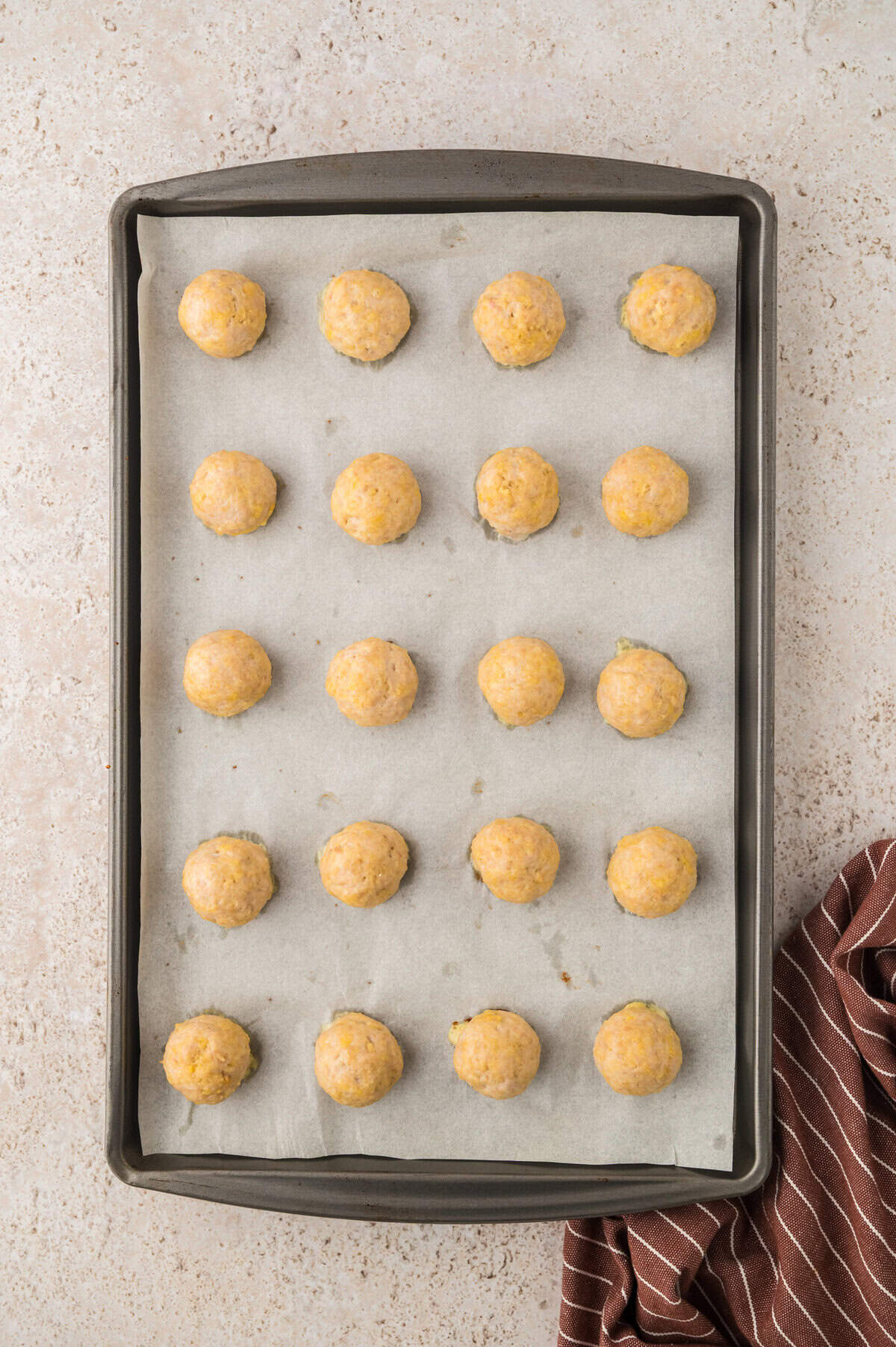 Chicken meatballs on baking sheet.