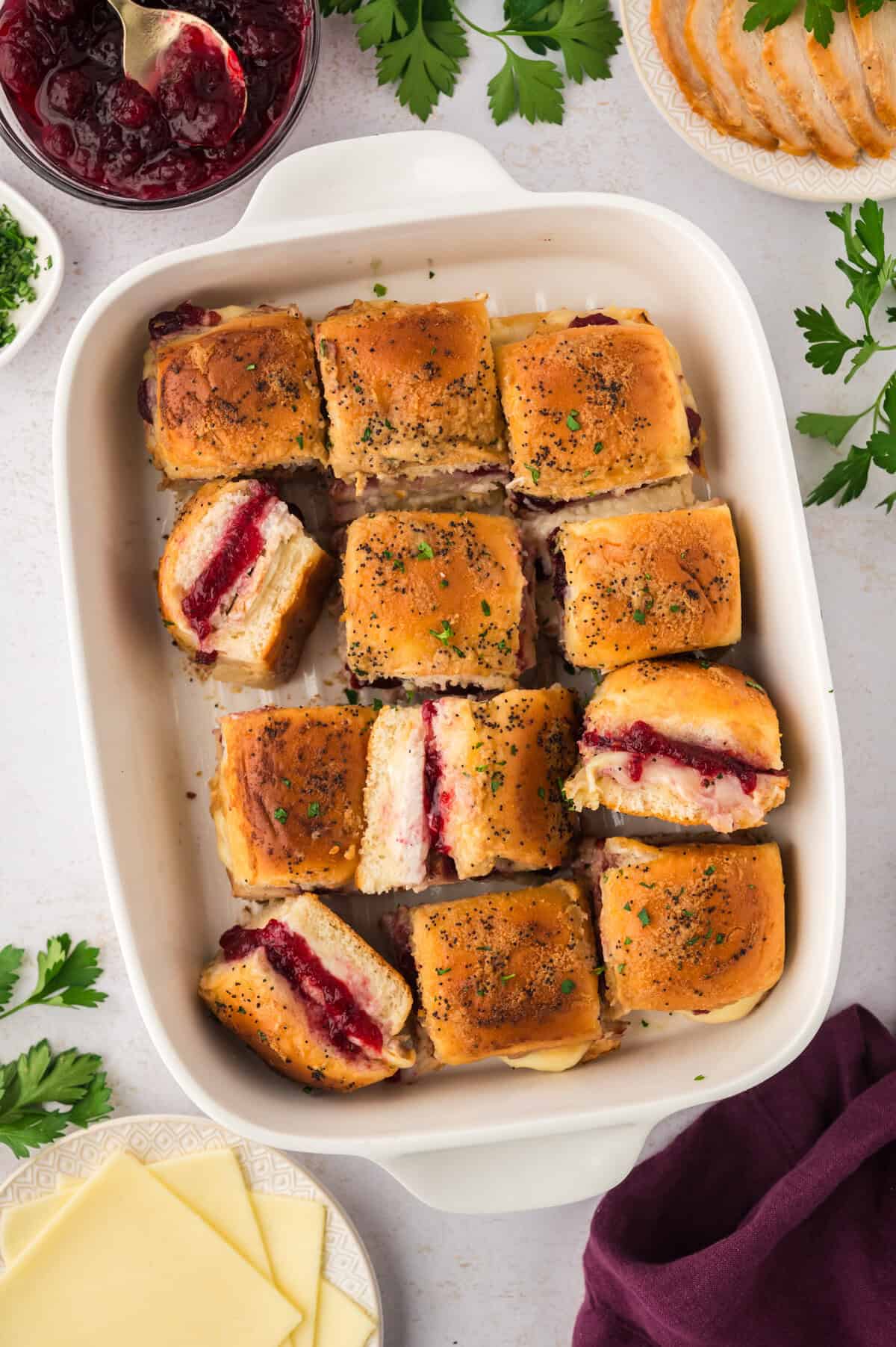 Baking dish full of turkey cranberry sliders.
