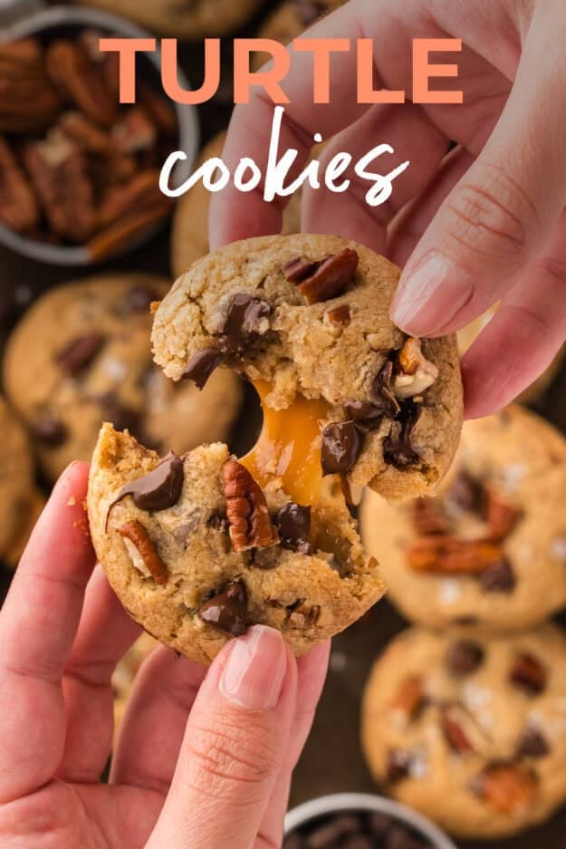 Hand pulling apart a cookie with a molten caramel center.