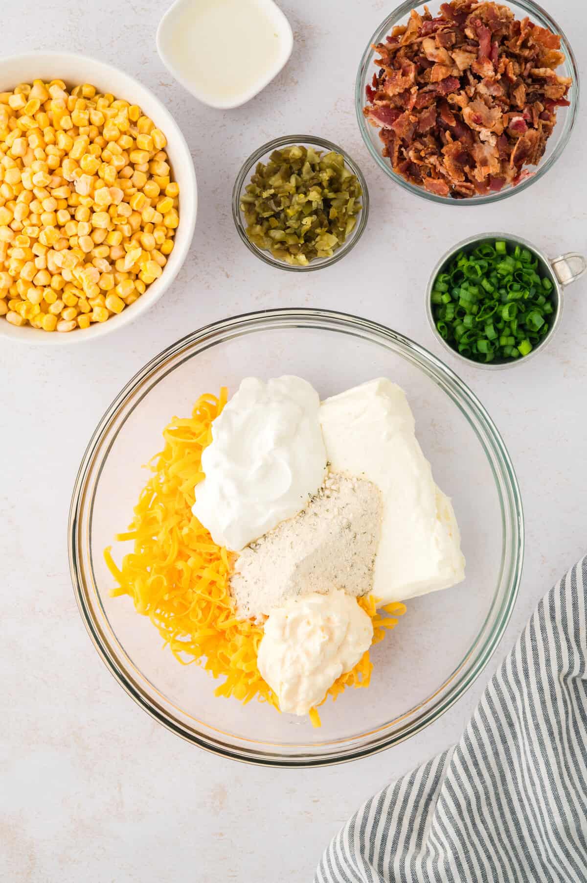 Cheese, mayo, sour cream, and ranch seasoning in mixing bowl.