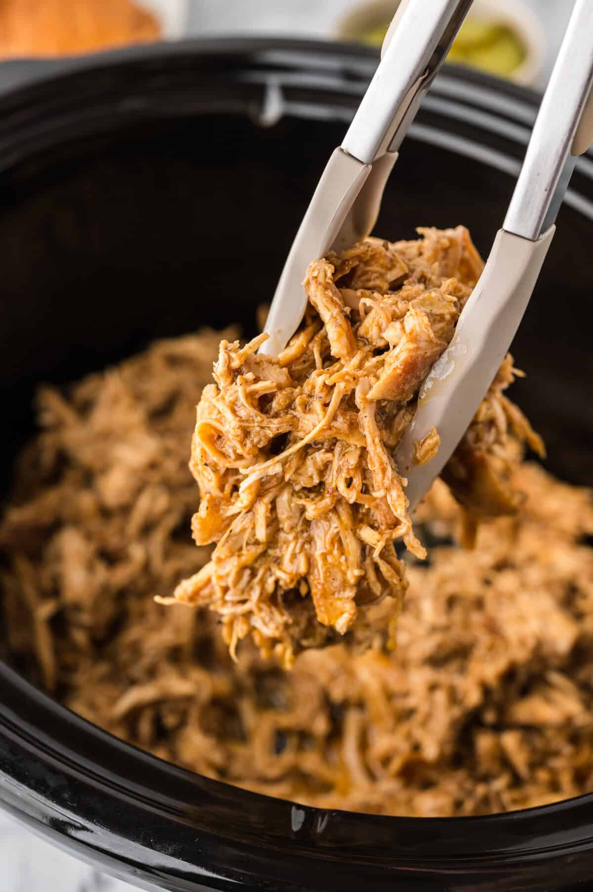 Shredded Nashville hot chicken in crockpot.