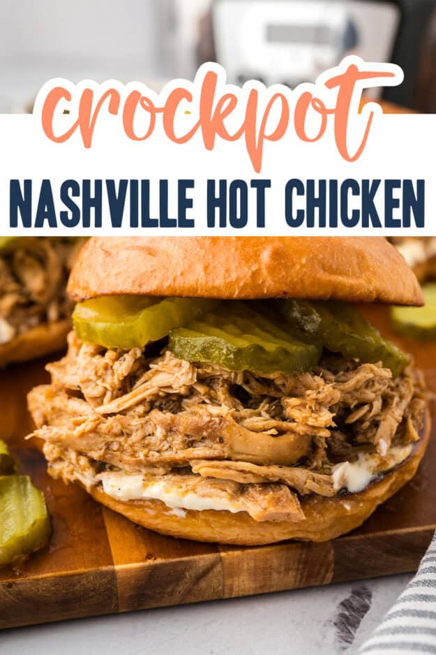 Nashville hot chicken sandwich on wooden board.