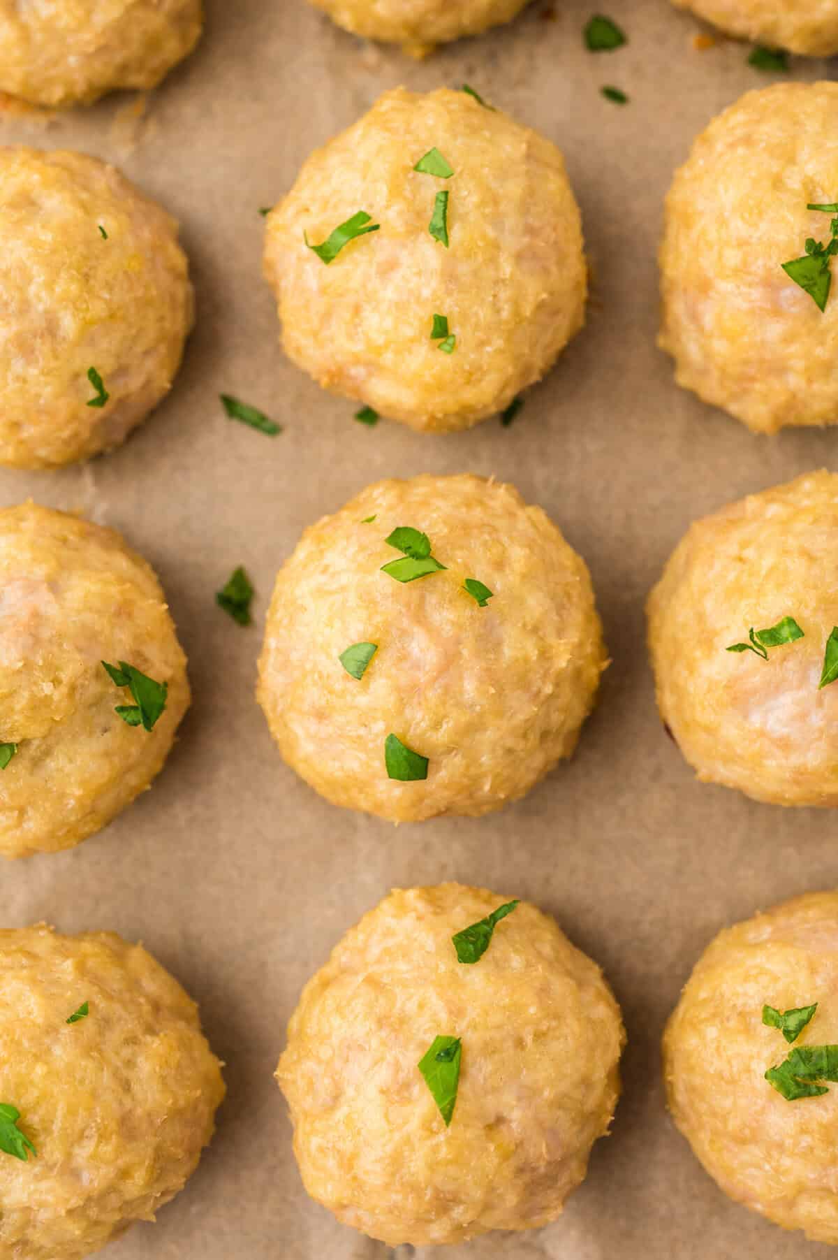 Baked chicken meatballs on sheet pan.