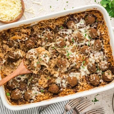 Casserole dish filled with baked meatballs and rice.