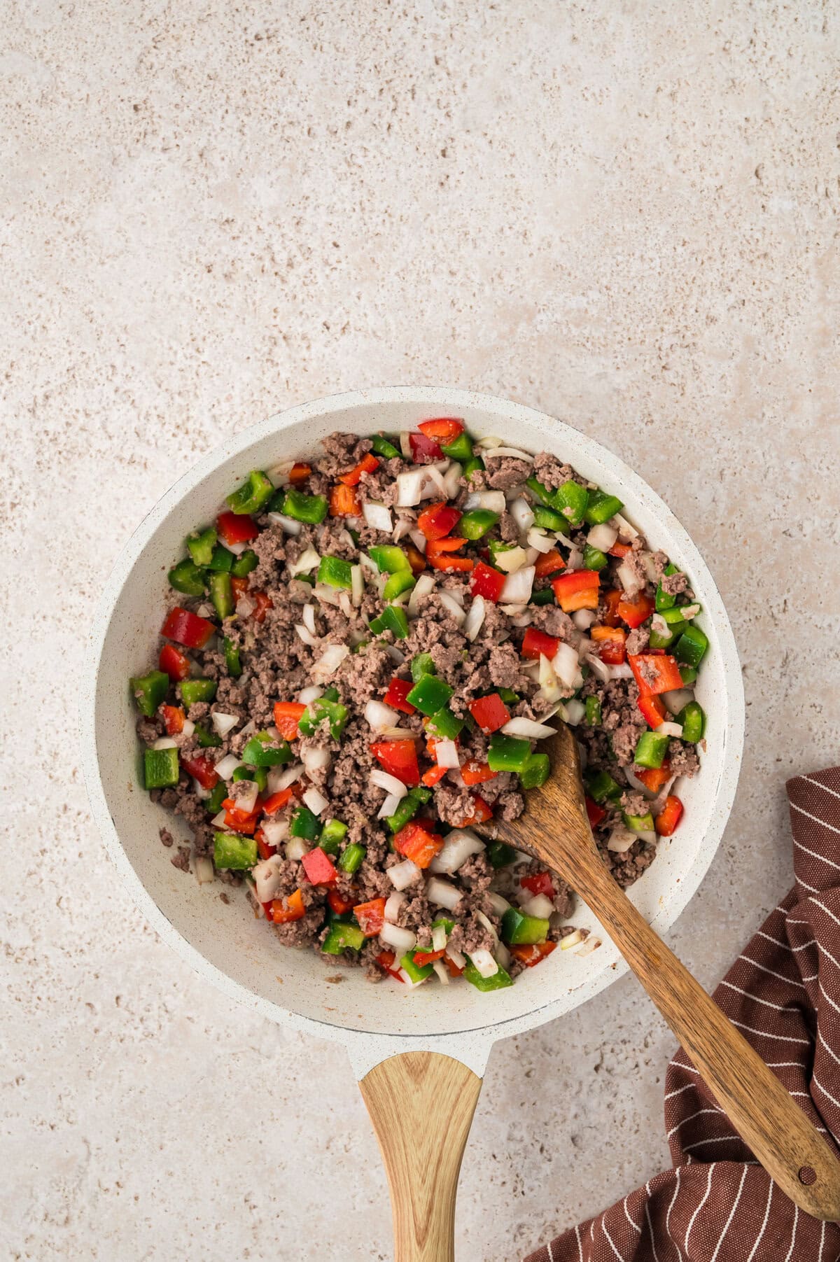 Beef and peppers in a skillet.