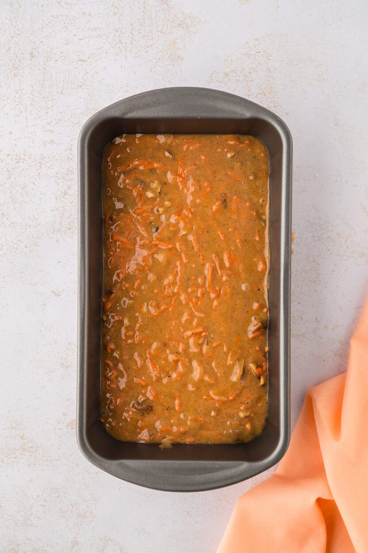 Batter for carrot cake bread in bread pan.