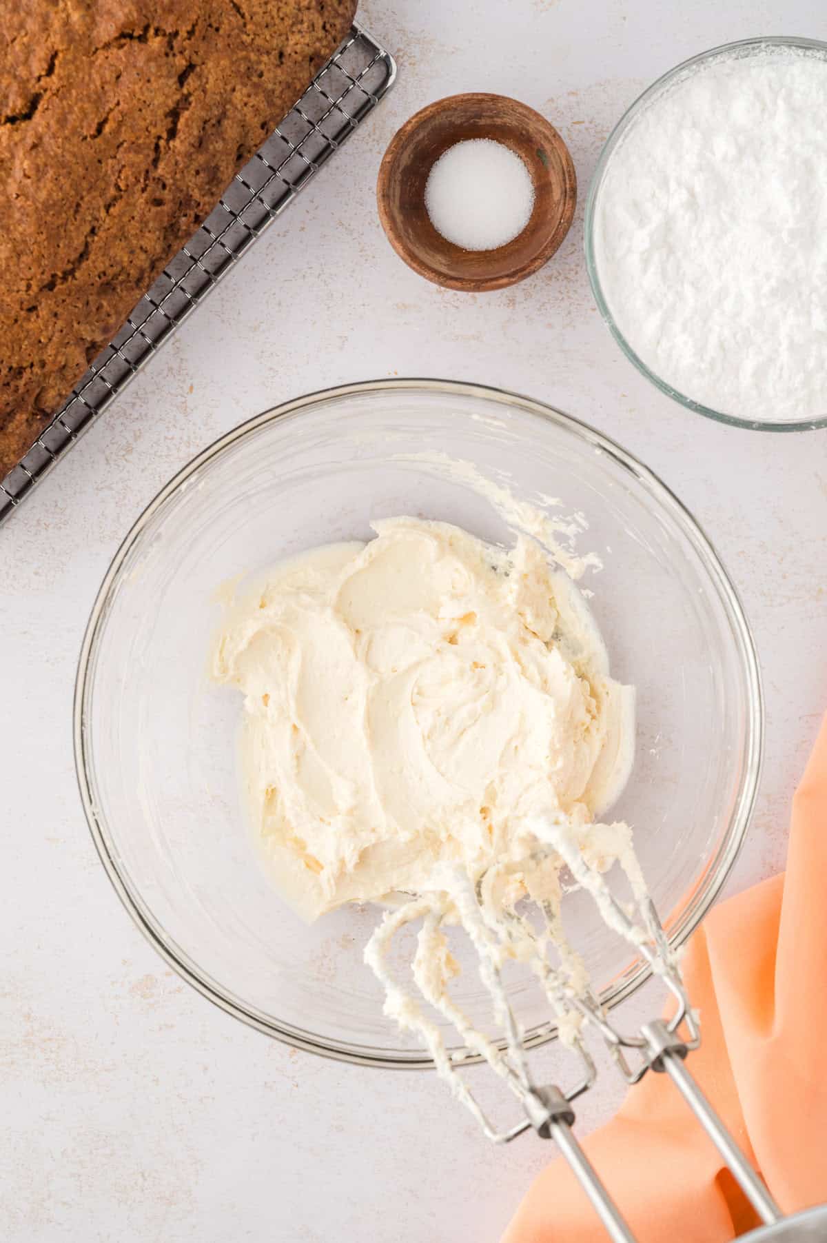 Cream cheese frosting in glass mixing bowl.