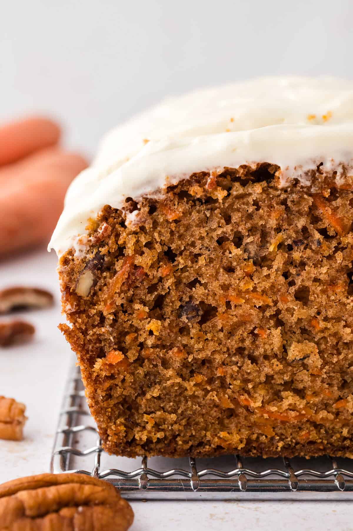 Sliced carrot cake bread on cooling rack.