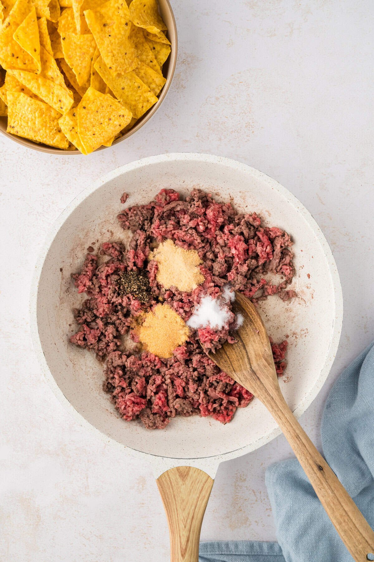 Seasoned beef in skillet.