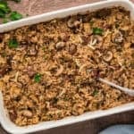 Baked rice casserole with steak and mushrooms in baking dish.