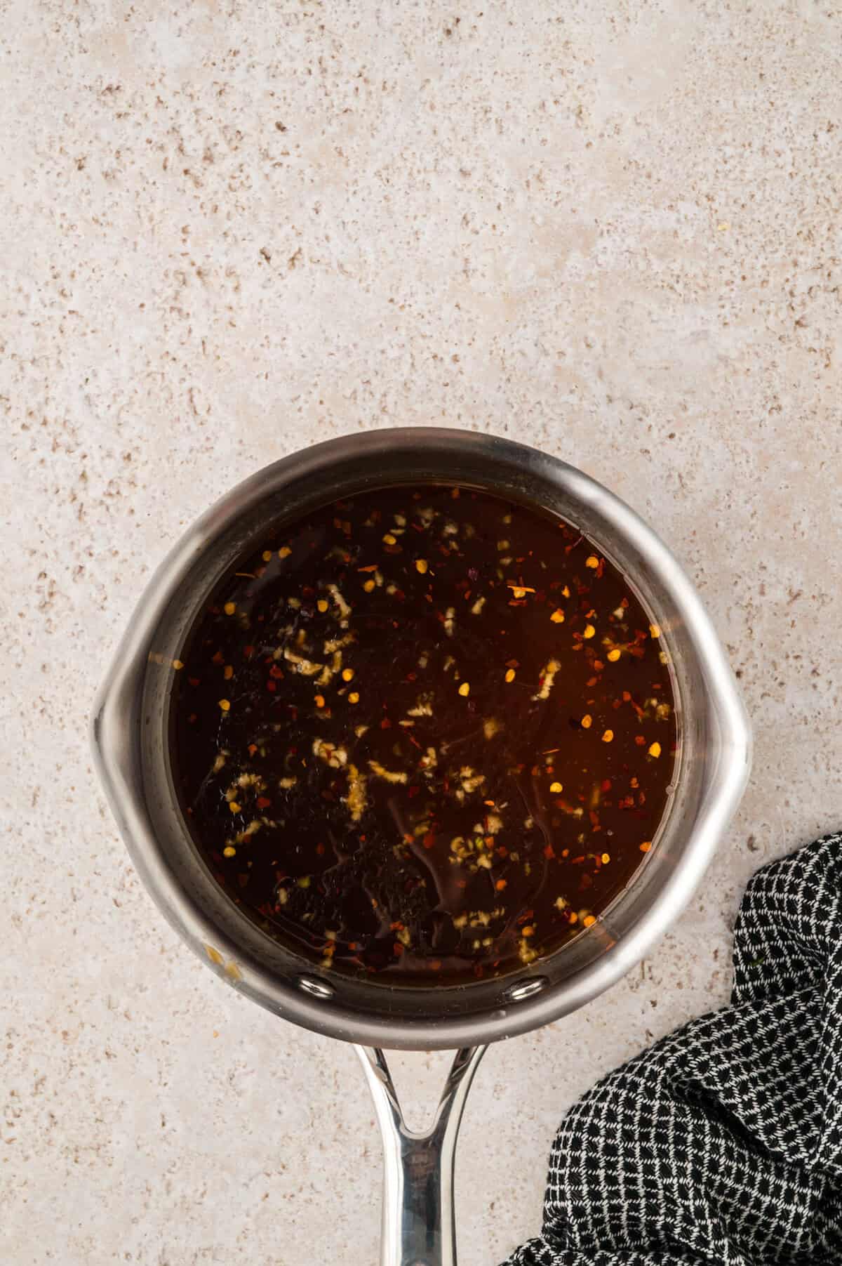Sauce for meatballs in saucepan.