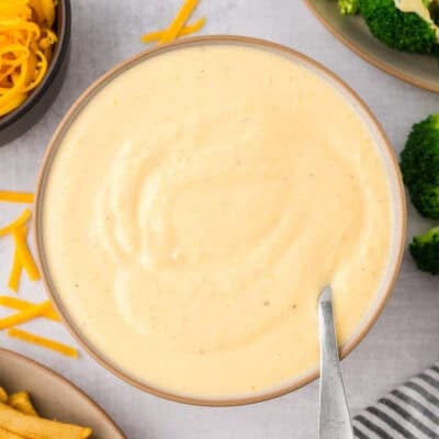 Bowl full of cheddar cheese sauce.