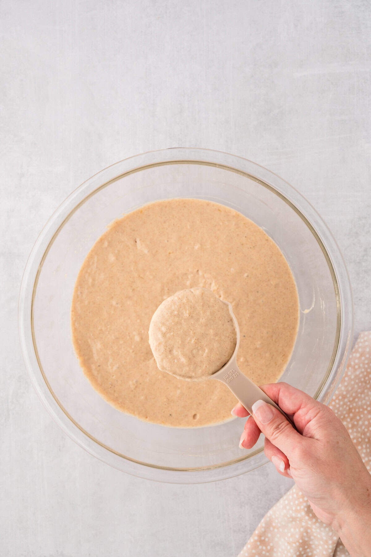 Scoop of pancake batter being measured out.