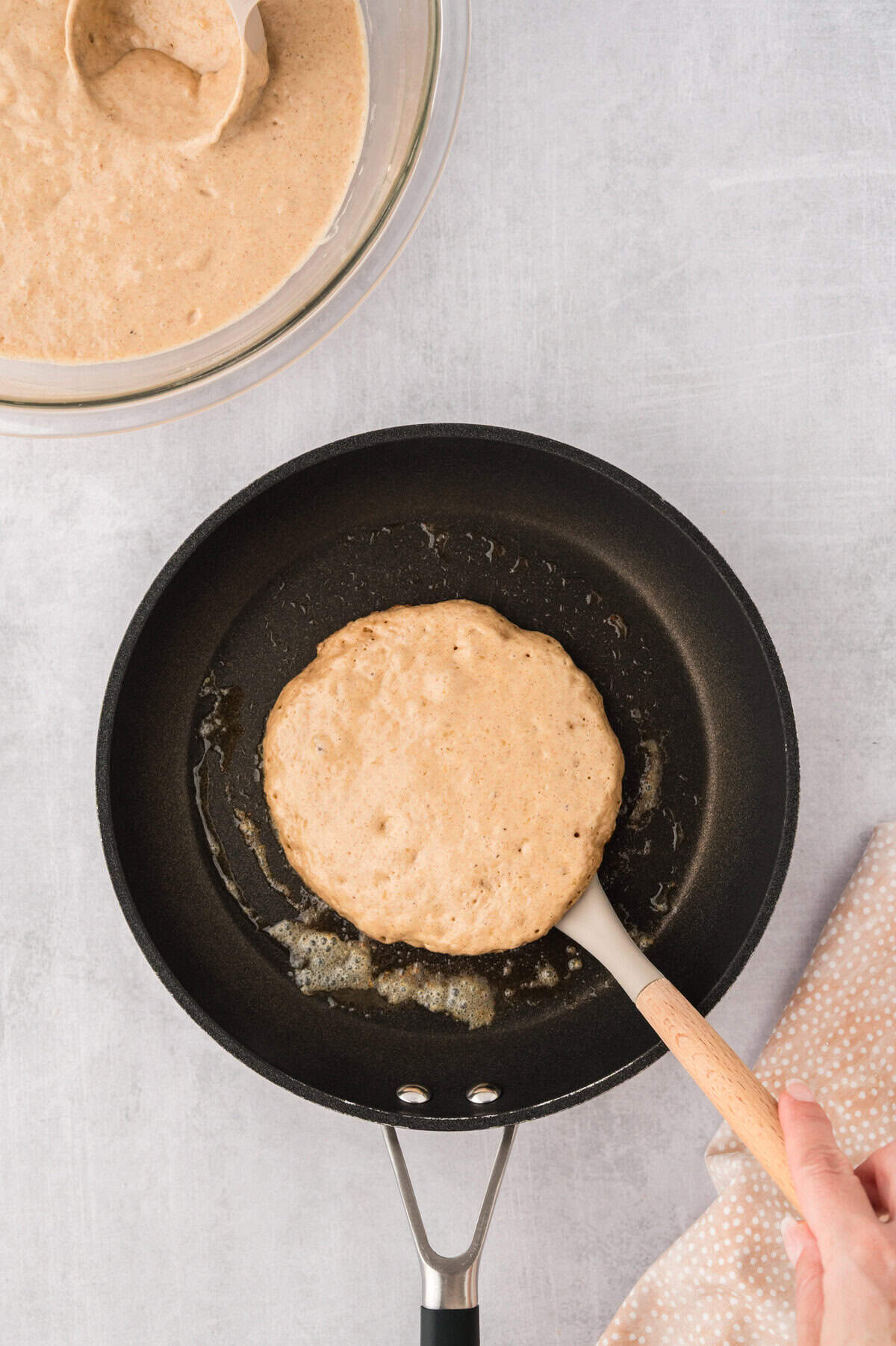 Pancake cooking in skillet.