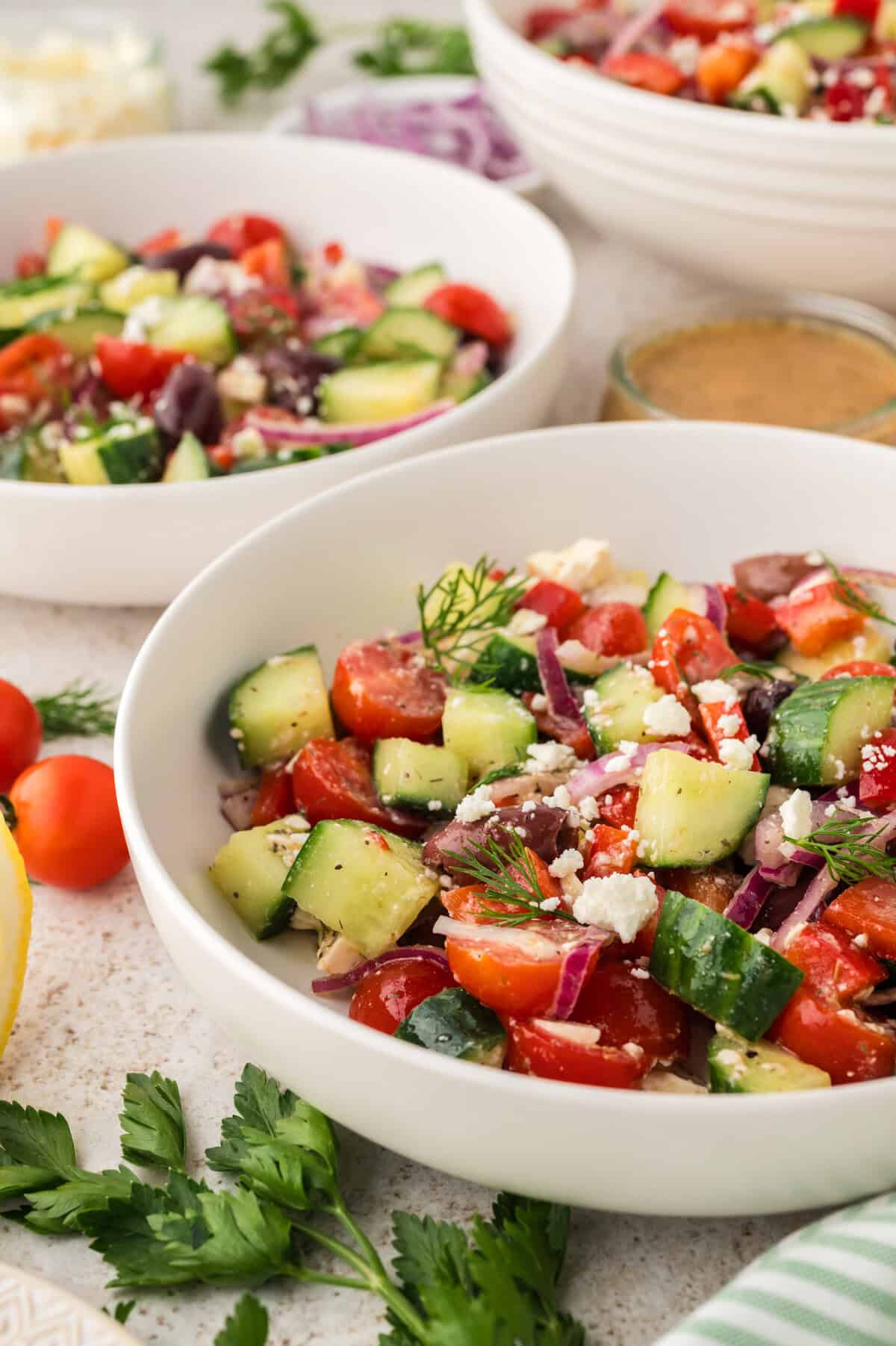 Serving bowl full of Greek cucumber salad.