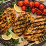 Grilled marinated chicken on serving platter.