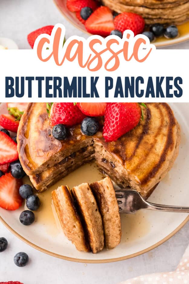 Cut pancakes on plate with berries and syrup.