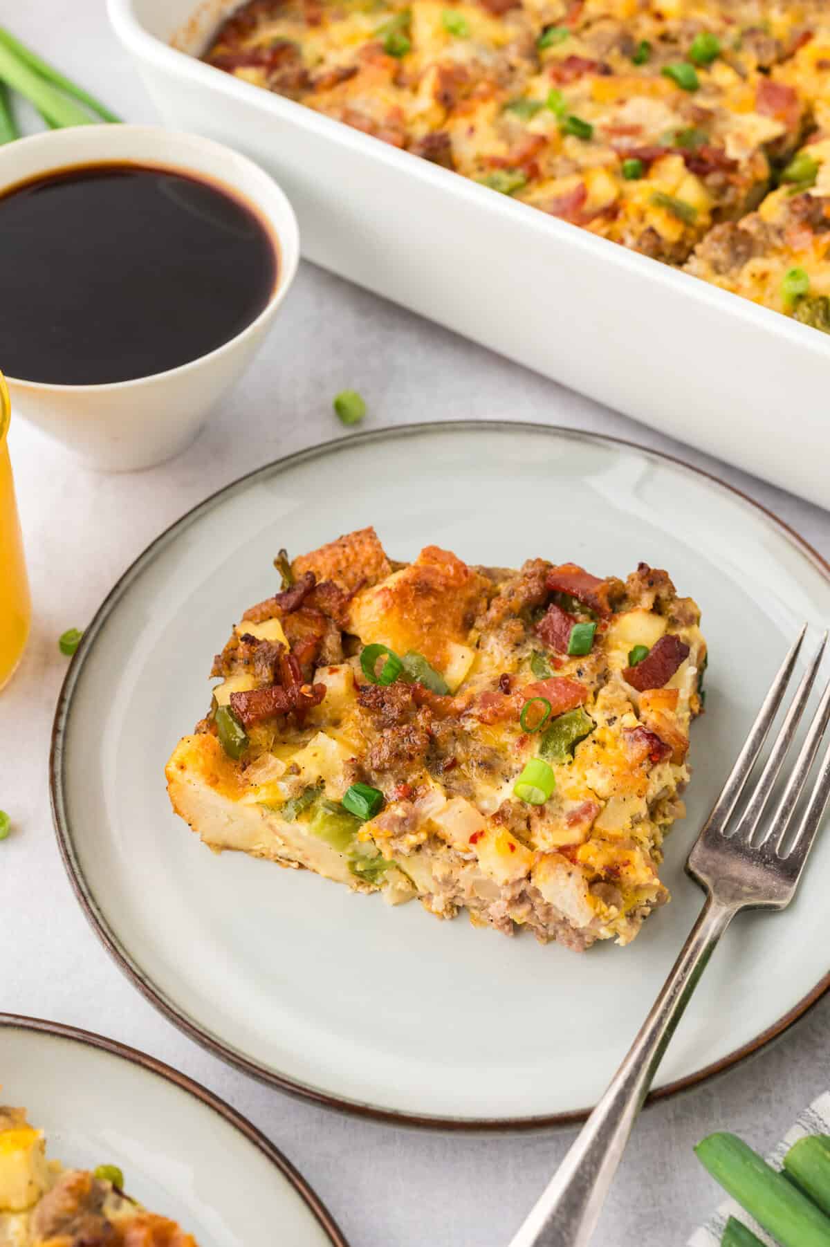 Plate with a slice of cowboy breakfast casserole on top.