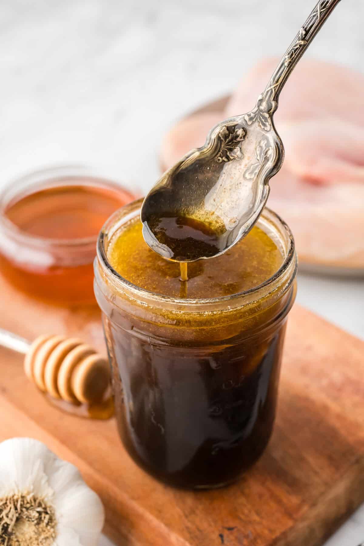 Easy chicken marinade in mason jar with spoon.