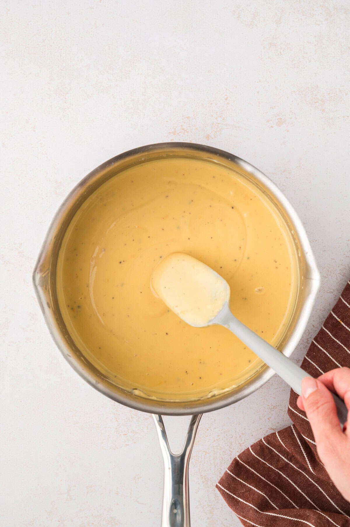 Beer cheese sauce in sauce pan.