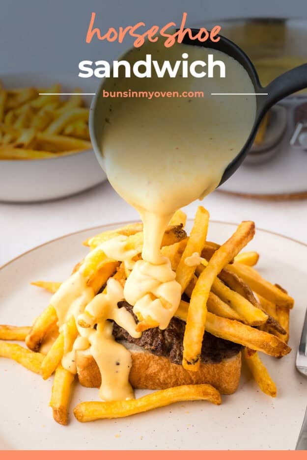 Cheese sauce being poured over burger and fries.