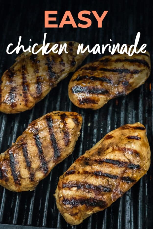 Grilled marinated chicken breasts on grill.