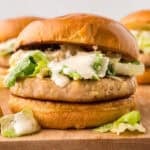Chicken Casear salad burger on wooden board.