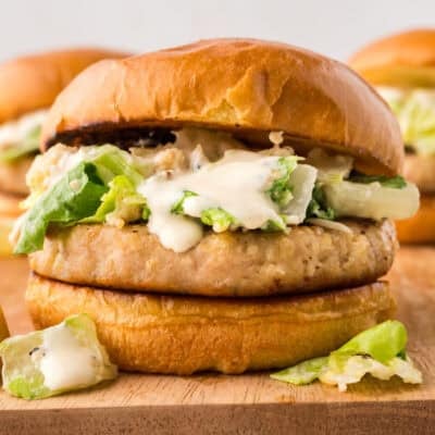 Chicken Casear salad burger on wooden board.