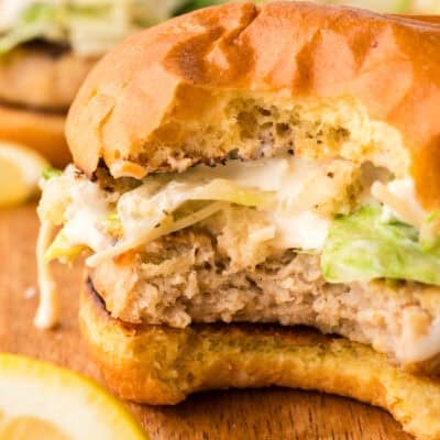 Bite taken out of a chicken Caesar burger.
