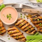 Grilled ranch chicken breasts on platter.