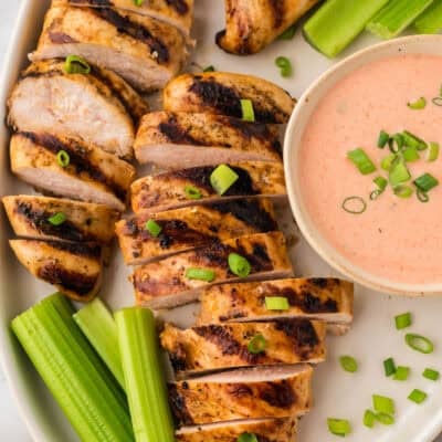 Buffalo ranch grilled chicken sliced on a white platter.