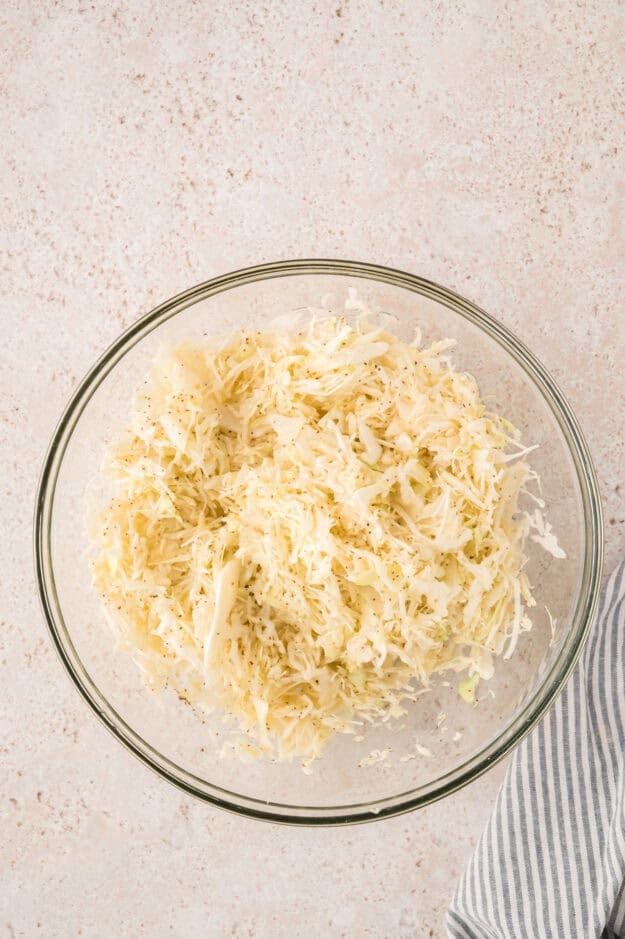 Dressing poured over vinegar coleslaw.
